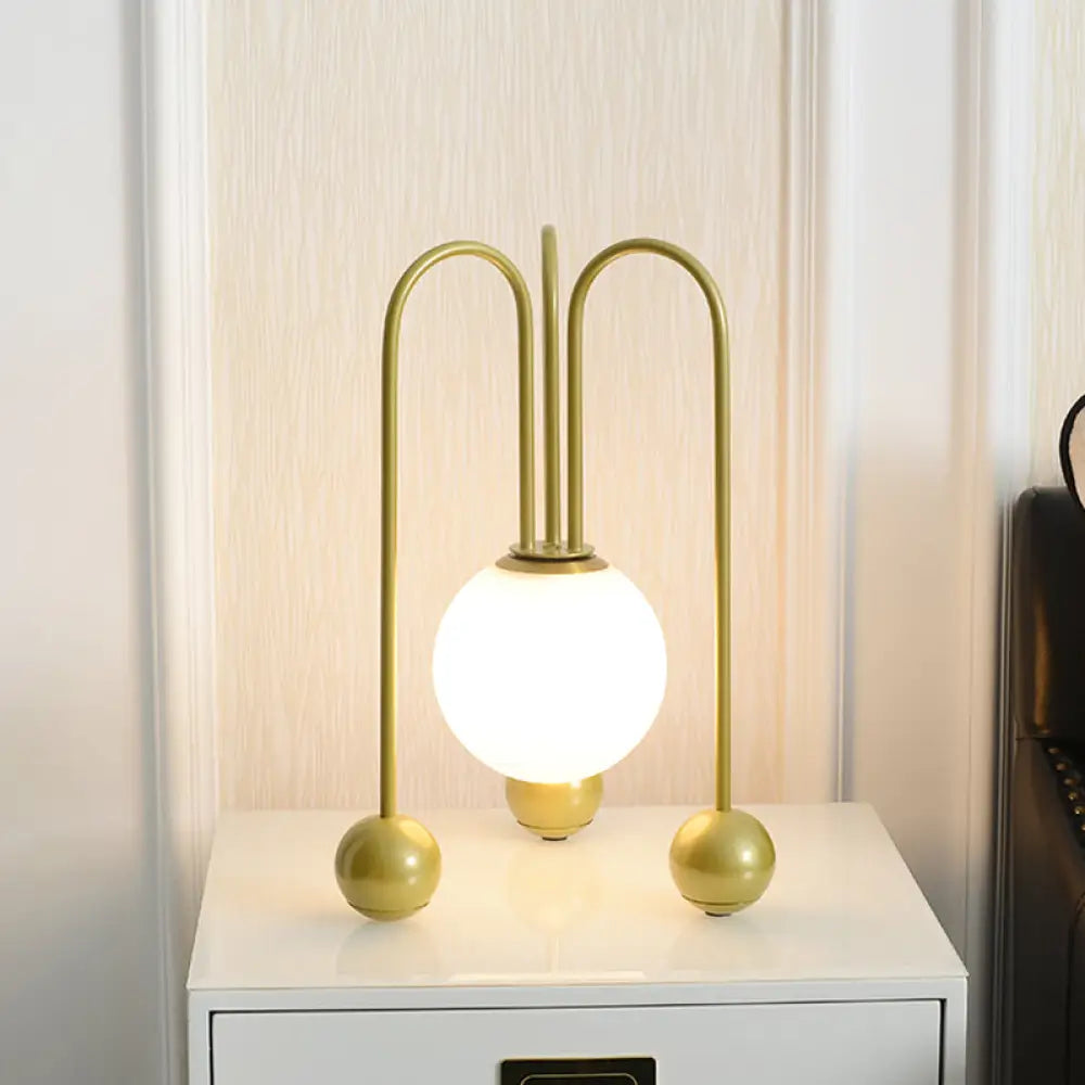 metal table lamps with a matte black finish for a sleek appearancemetal table lamps with a matte black finish for a sleek appearanceContemporary U-Shaped Metal Table Lamp with Opal Glass Shade - Black/Gold, Warm/White Light, 1 Bulb